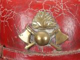 a red fire hydrant with a gold emblem on it