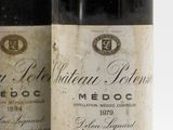 two bottles of red wine sitting next to each other on a white surface