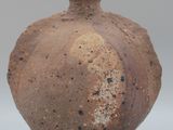 a brown vase that is sitting on a table