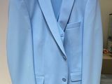 light blue blazer with black lapel on hanger in room