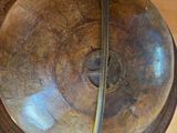 a wooden globe hanging from the ceiling in a room