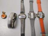 three watches are sitting next to each other on a table
