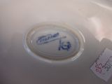 a white bowl with a blue and white design on it