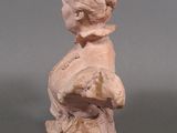 a small statue of a child holding a teddy bear