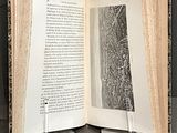 a open book with a picture of a city on it