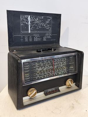 une vieille radio posée sur une table près d'un mur blanc