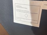 the label is on the back of a suitcase that is sitting on a table