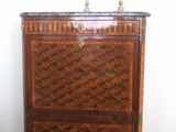a small chest of drawers with a marble top
