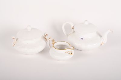 two white porcelain teapots and a saucer on a white surface