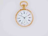 a gold pocket watch with roman numerals on it