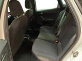 the back seats of a white car with a black seat belt