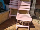 a pink chair and a pink chair sitting on a brick patio