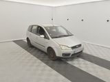 a small white car parked in a white room