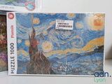 a picture of a puzzle box with a picture of a starry night