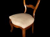a wooden chair with a white upholstered seat