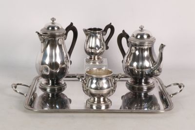 a silver tray with a silver tea set on it