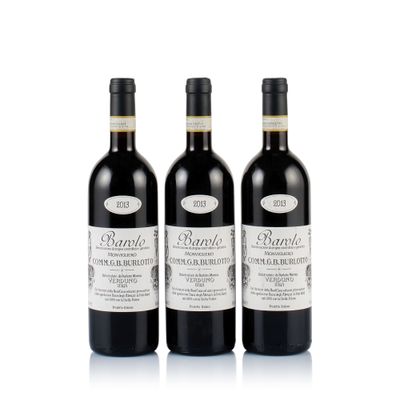 three bottles of wine sitting next to each other on a white surface