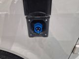 an image of a car with a blue plug attached to the side of it