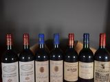 several bottles of wine are lined up in a row on a table