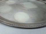 a silver tray with a silver handle on a table