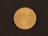 a close up of a gold coin on a black background