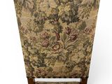 the back of a chair with a floral upholstered seat