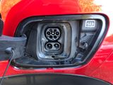 an electric car plugged in to an electric vehicle