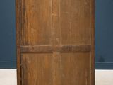 an old wooden cabinet with a marble top in front of a blue wall