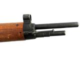 a close up of a rifle with a wooden barrel on a white background
