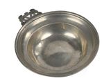 a small metal bowl with a chain around it