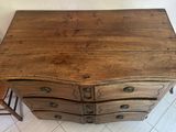 a small wooden table with four drawers and a chair