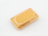 an image of a gold plated money clip on a white surface