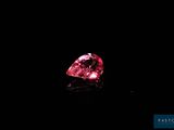 a pink diamond on a black background
