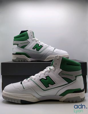 the new balance shoes are white and green with a black box
