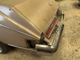an old car that is parked in a garage