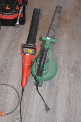 an image of a corded corded saw and a corded corded saw on a wood floor