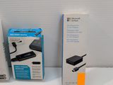 two boxes of nintendo wii controllers sitting next to each other on a white surface