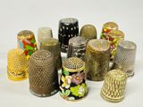 many different types of thimbles sitting on a white surface