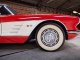 an image of a red and white car parked in a garage