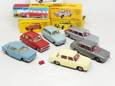 several toy cars are lined up in a row on a white surface