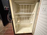 a small refrigerator with a basket in it on a pallet