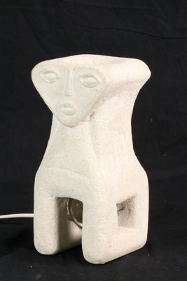 a white ceramic sculpture of a woman ' s face on a black background