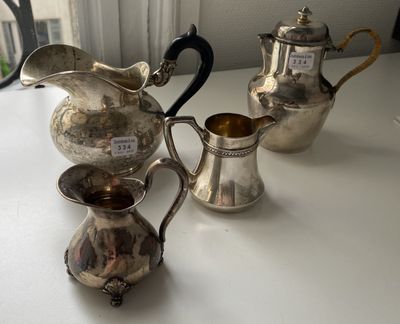 three silver teapots sitting on a table next to each other