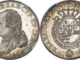 une pièce d'argent sur laquelle figure l'effigie d'un homme coiffé d'une couronne
