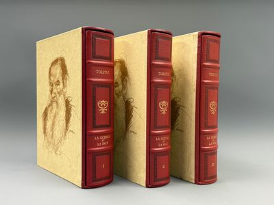 deux livres rouges sur lesquels figure le dessin d'un homme barbu