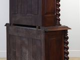 an old wooden cabinet with a door on top of it