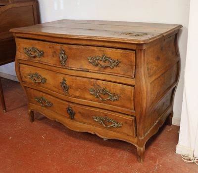 a wooden chest of drawers in the corner of a room