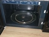 a microwave with a pan inside of it sitting on a counter
