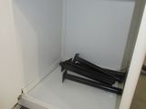 a white shelf with a magazine holder on top of it