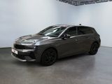 the grey car is parked in a large room with white walls
